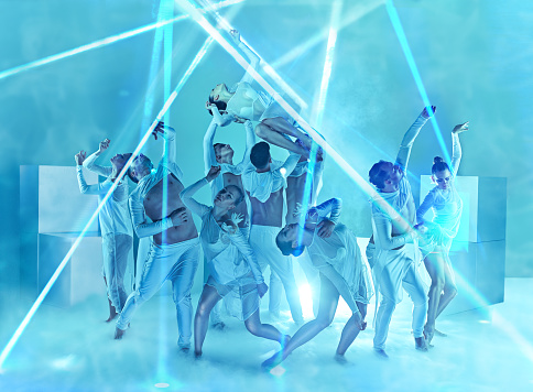 The group of modern ballet dancers on blue studio background