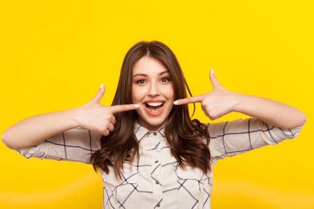 istock Woman smiling and pointing at mouth 811400348