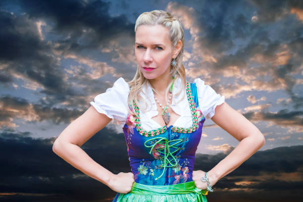 portrait of blonde woman in dirndl looking upset - dirndl traditional clothing austria traditional culture imagens e fotografias de stock