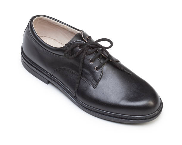 istock Black leather protective shoes isolated on white 811403774