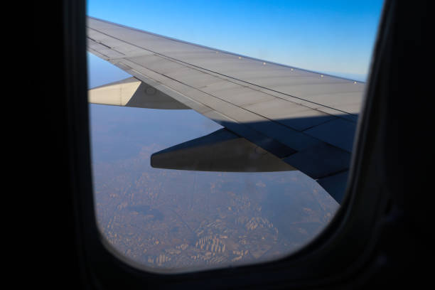 istock Scenery outside window where airliner wings are visible 811420706