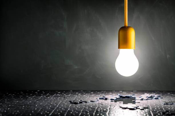 istock Light bulb and Jigsaw Puzzle - Blackboard Vintage Table Grunge 811427446