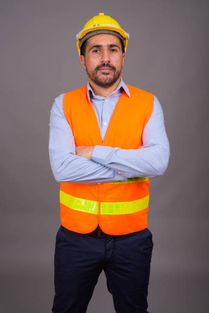 istock Studio shot of bearded Persian man construction worker against gray background 811433826