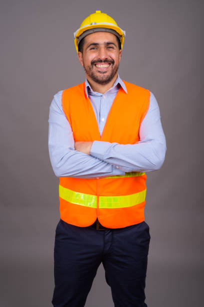 istock Studio shot of bearded Persian man construction worker against gray background 811433858