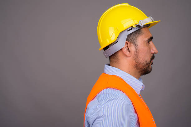 istock Studio shot of bearded Persian man construction worker against gray background 811433920