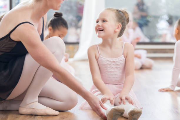 istock Happy girl talks with ballet instructor 811450788