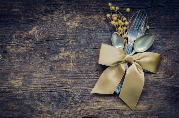 Thanksgiving autumn place setting with cutlery on wooden background. Thanksgiving table setting cutlery on the autumn background. Thanksgiving holidays background concept. Copy space. Top view.