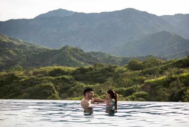 istock Happy couple in the pool enjoying their vacations 811454084