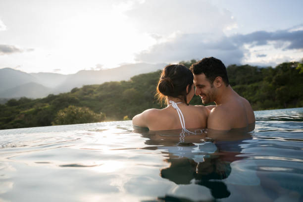 istock Happy couple looking very affectionate in the pool 811454186