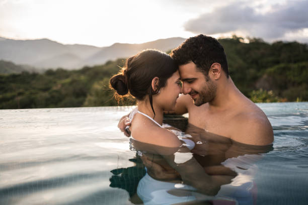 istock Loving couple enjoying a romantic getaway in the pool 811454204