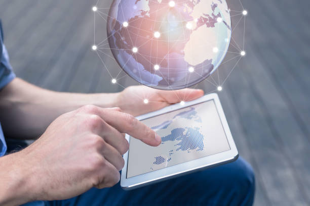 istock World wide business concept, person using AR tablet, 3D globe 811459112