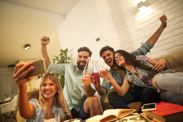 istock Friends having fun and taking group Selfie 811470356