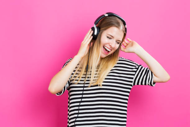 istock Happy young woman with headphone 811470492