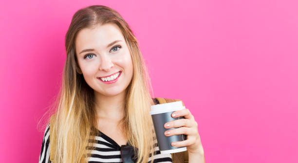 istock Happy young woman drinking coffee 811470498