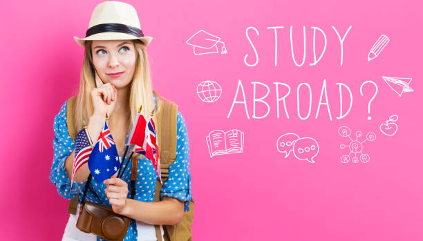 istock Study Abroad text with young woman with flags 811470538