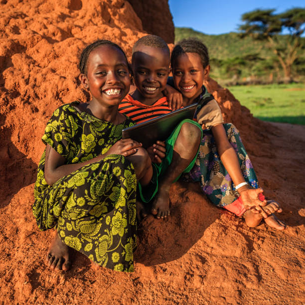 istock Little African children using digital tablet, East Africa 811470896