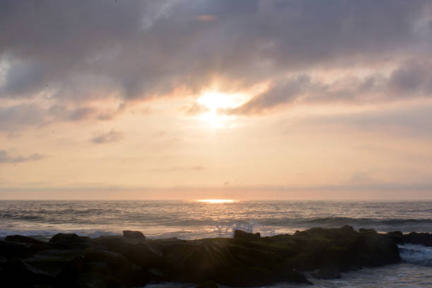 istock Heavenly Summer Seashore Sunrise Over Rock Jetty on Beach 811478464