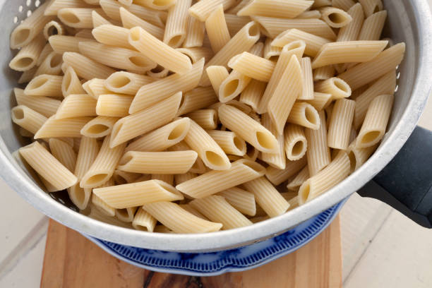 Penne pasta in an old colander - CloseUp