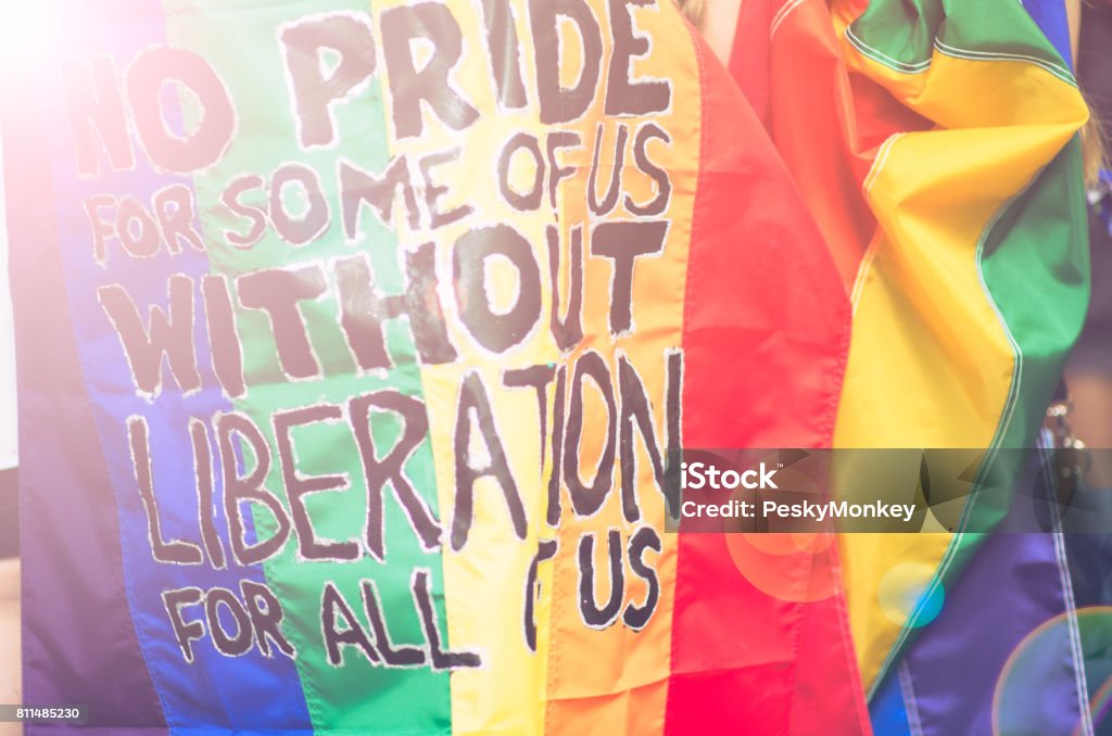 Gay Pride Protest Message Protest message handwritten on rainbow flag at the annual Gay Pride Parade in Greenwich Village, New York City, USA Protest Stock Photo