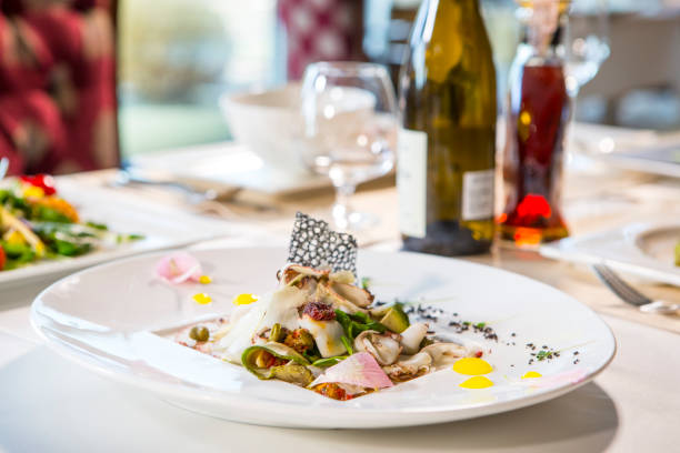 istock Served table with dishes from meat, chicken and fish with wine and whiskey. Romantic dinner in the restaurant by candlelight 811492486
