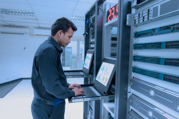 Network administrator working in data center room stock photo