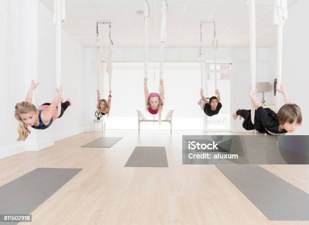 Group Of Children Practicing Aerial Yoga Stock Photo - Download Image Now - Aerial Yoga, Child, Flying