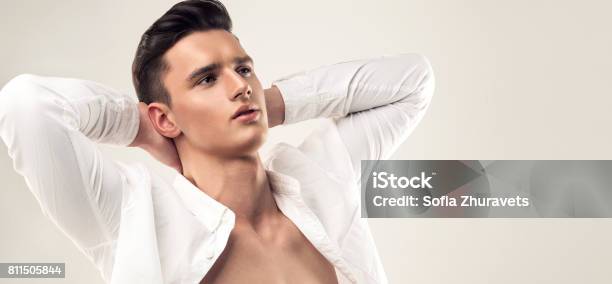 Handsome Man With Trendy Hairstyle Dressed In A Unbuttoned White Shirt Stock Photo - Download Image Now