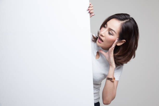 istock Excited young Asian woman with blank sign. 811535876