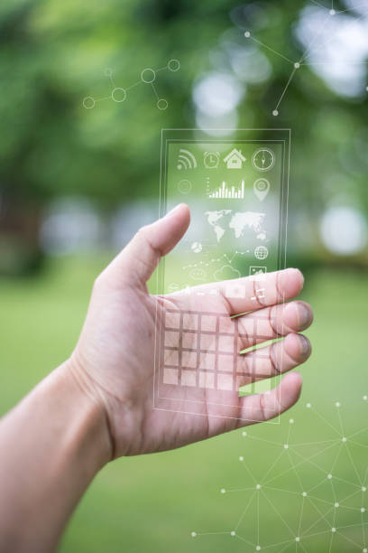 istock A man using the transparent phone with the future technology . Technology concept, future and futuristic technology. 811545122