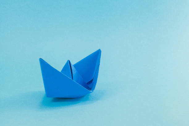 istock Blue Paper boat on cyan background. 811552084