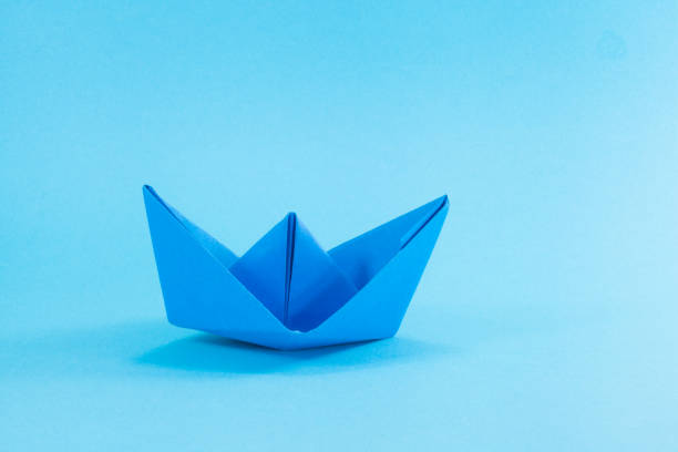 istock Blue Paper boat on cyan background. 811552086