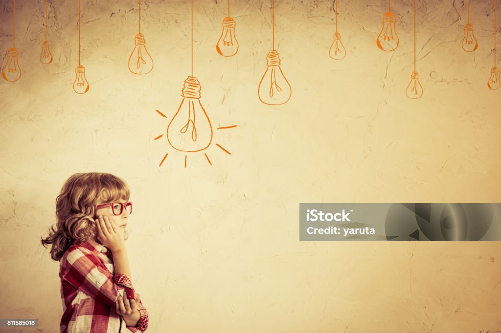 Idea Hipster kid thinking. Idea concept. Drawing bulb lump. Retro toned Arts Culture and Entertainment Stock Photo