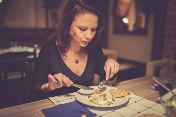 istock Woman eating at a restaurant 811585380