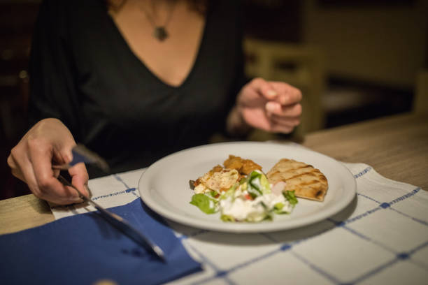 istock Woman eating at a restaurant 811591988