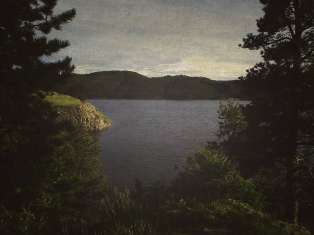 Pactola Lake Reservoir in South Dakota (Retro Style) Vintage lake shot with trees on side during June in South Dakota. 1960s style image filter done in Photoshop. black hills national forest stock pictures, royalty-free photos & images