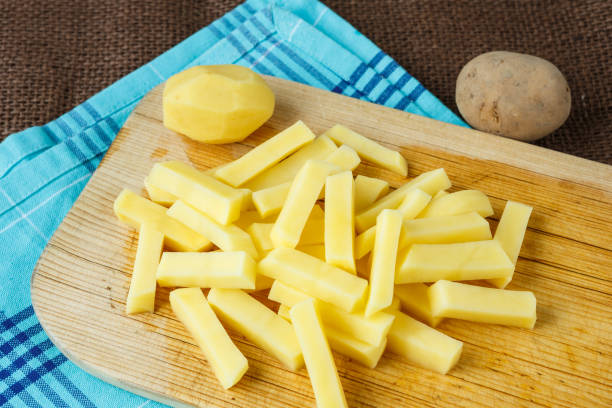 istock Raw potato sliced strips prepared for fries 811605348