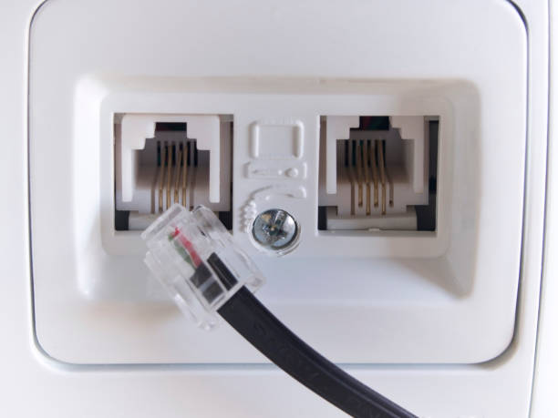 istock Telephone jack on the house wall 811605642