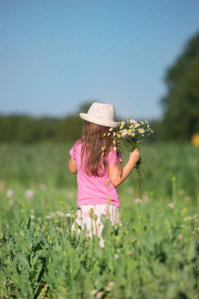 istock Girl with flowers from behind 811625404