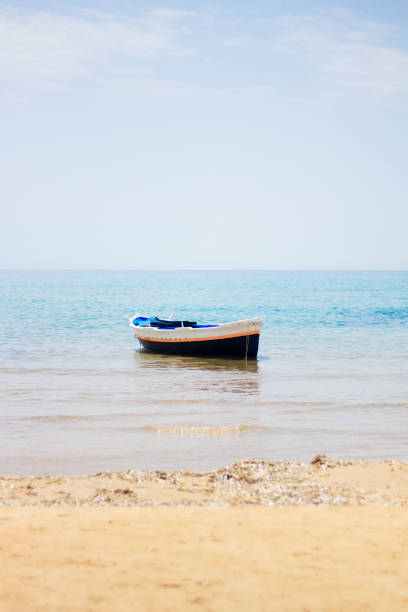 istock Beach Idyll: Sunlit Fishing Boat Moored in Mediterranean 811632684