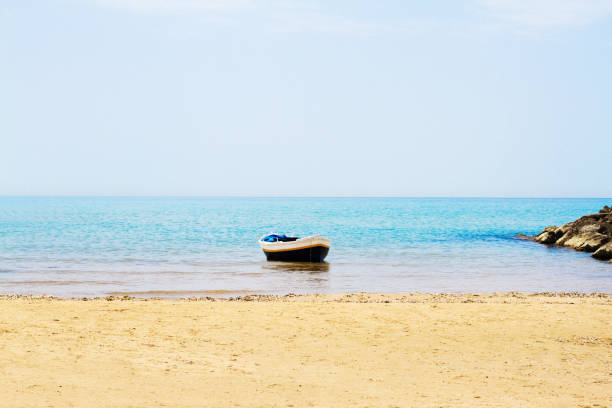 istock Beach Idyll: Sunlit Fishing Boat Moored in Mediterranean 811632918