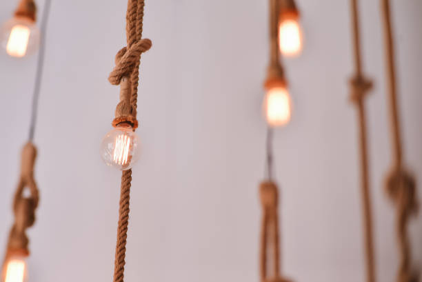 istock Electric lamps hanging on a rope 811644236