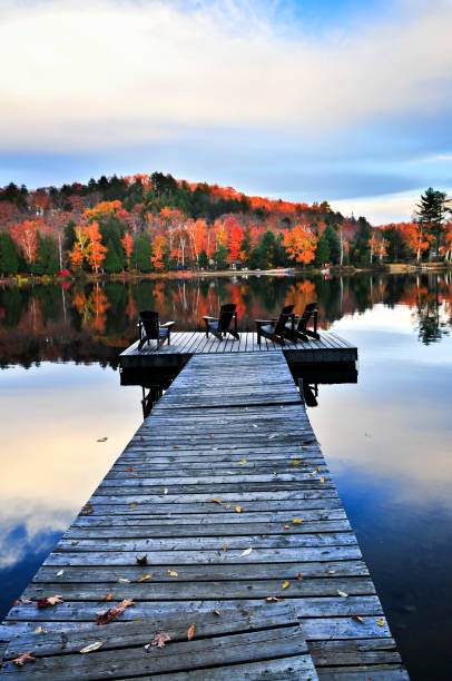 istock Wooden dock on autumn lake 811661126