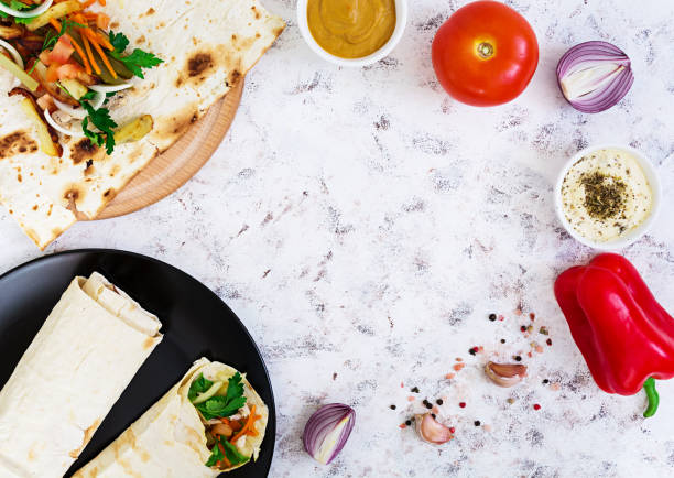 istock Shawarma sandwich with ingredients on white background. Top view 811682270