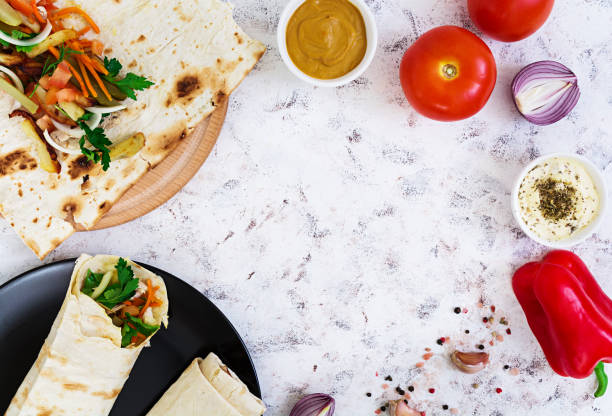 istock Shawarma sandwich with ingredients on white background. Top view 811682296