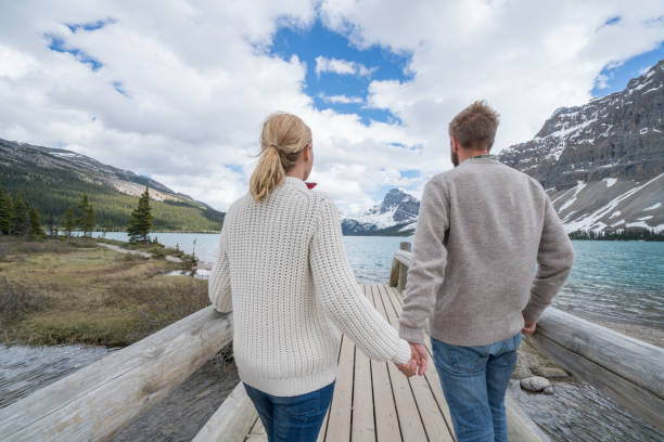istock Young couple relaxing by the lake 811689794