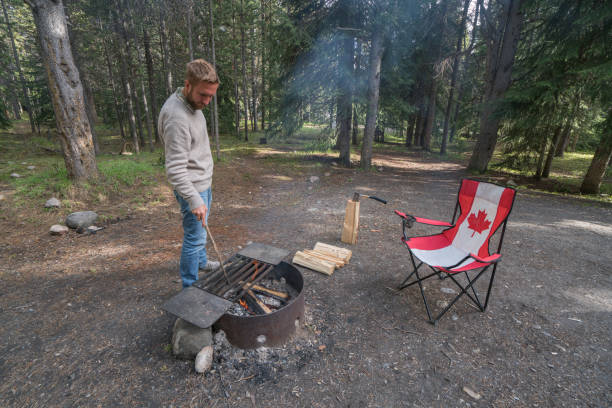 istock Man chopping wood at campground in Springtime 811704608