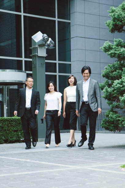 istock Asian business people walking to the office 811704826