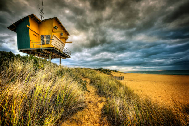 Stormy skies over the surf lifesaving tower at main beach at Lakes Entrance, Victoria