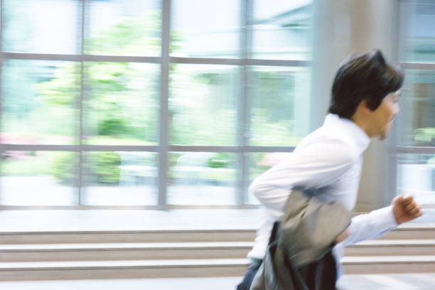 istock Business man running through building, blurred 811709296