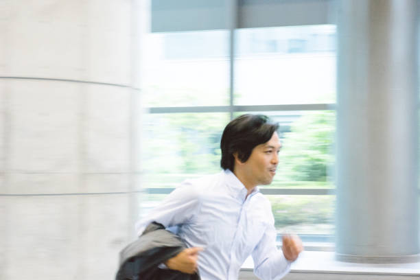 istock Business man running through building, blurred 811709572